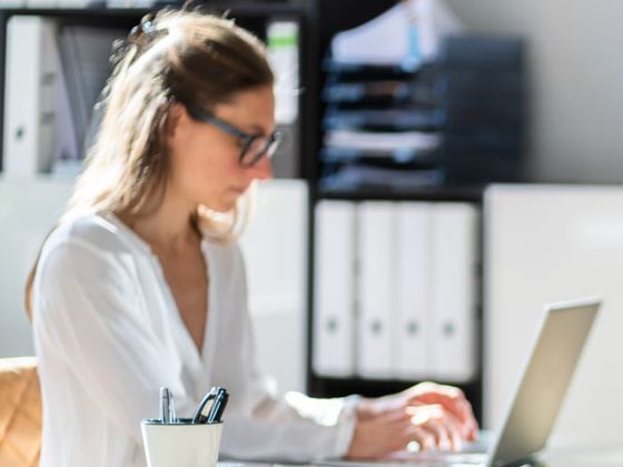 An advocate at her desk, working through a case on her laptop
